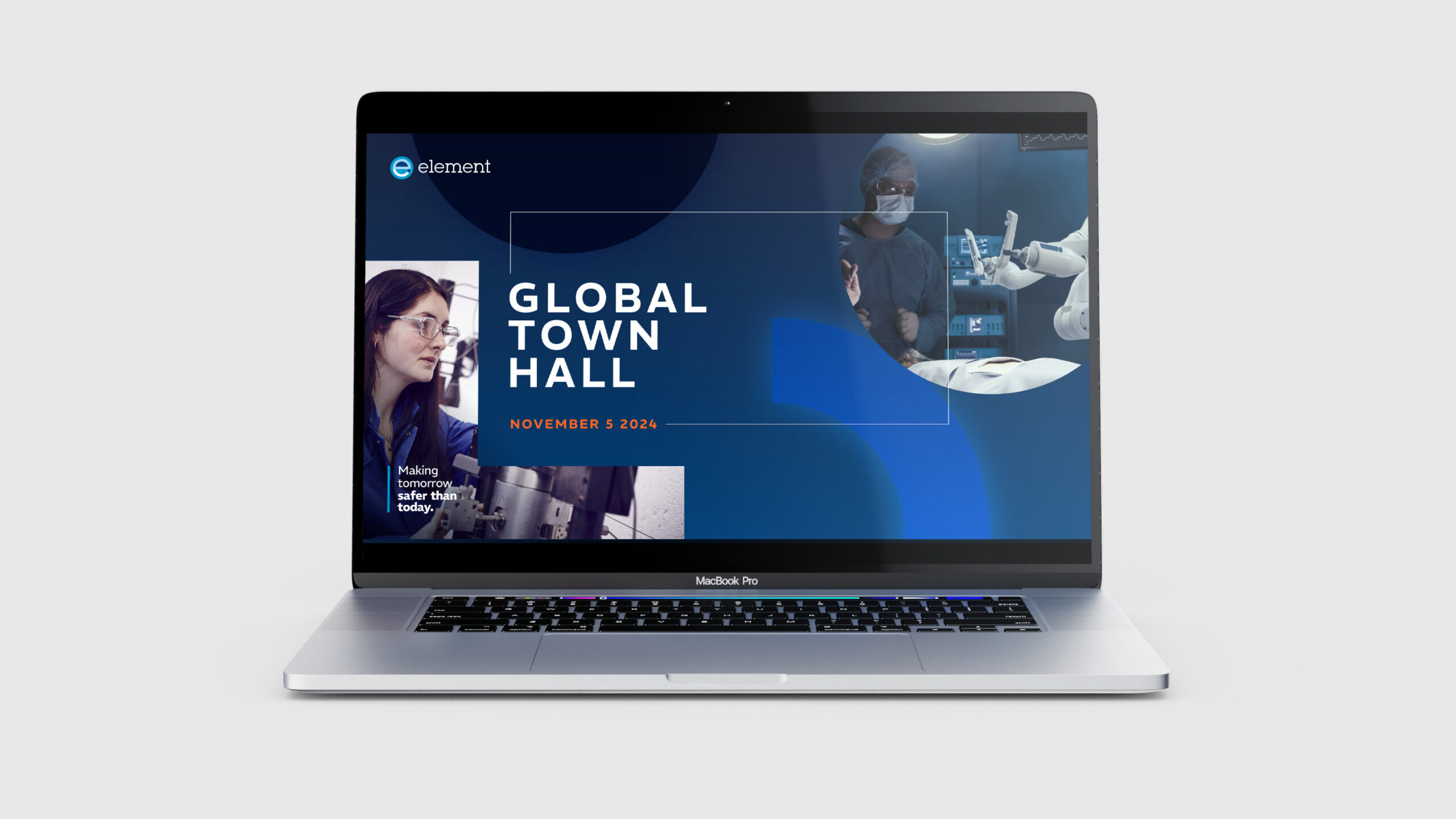 A laptop mockup displaying an Element 'Global Town Hall' presentation slide dated November 5, 2024, featuring images of laboratory testing and robotic surgery on a dark blue background.