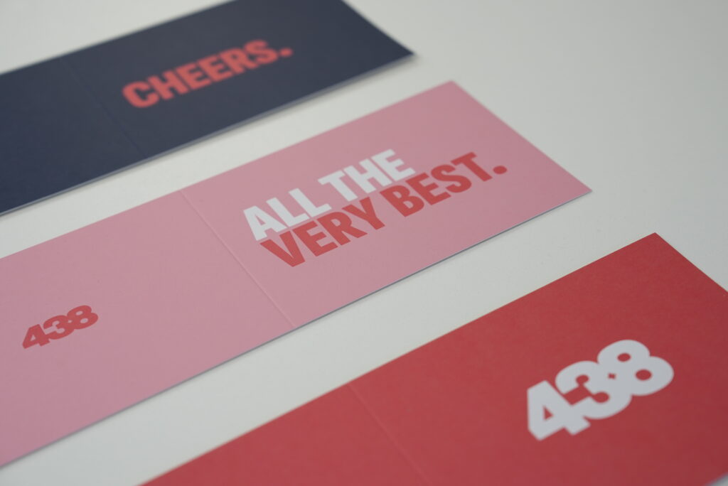 three cards with Cheers, All the best and 438 on them